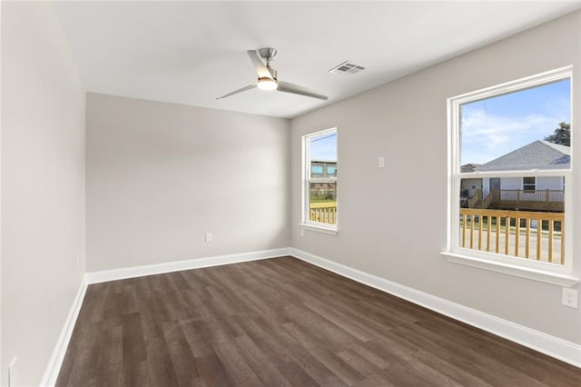 unfurnished room with dark hardwood / wood-style flooring, ceiling fan, and plenty of natural light