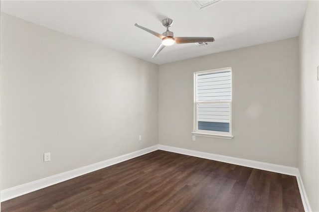 spare room featuring dark hardwood / wood-style flooring and ceiling fan