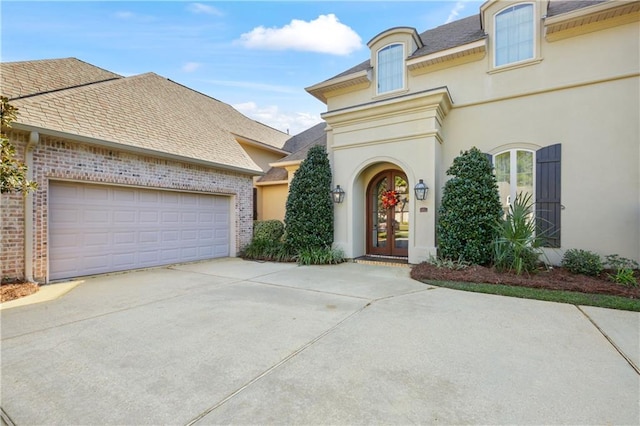 view of front of property with french doors and a garage