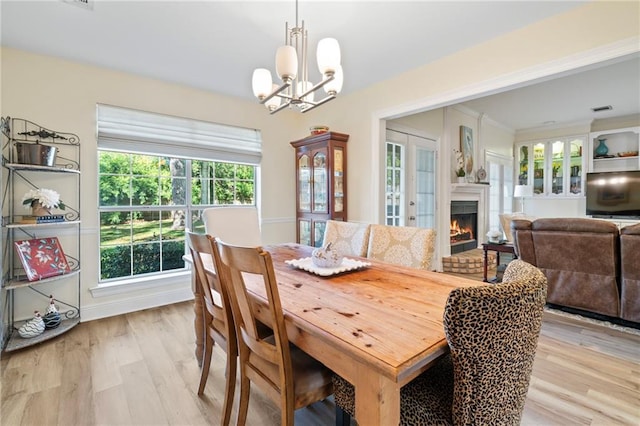 dining room featuring a notable chandelier and light hardwood / wood-style floors