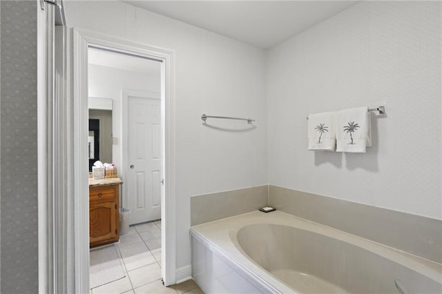 bathroom with vanity, tiled bath, and tile patterned floors