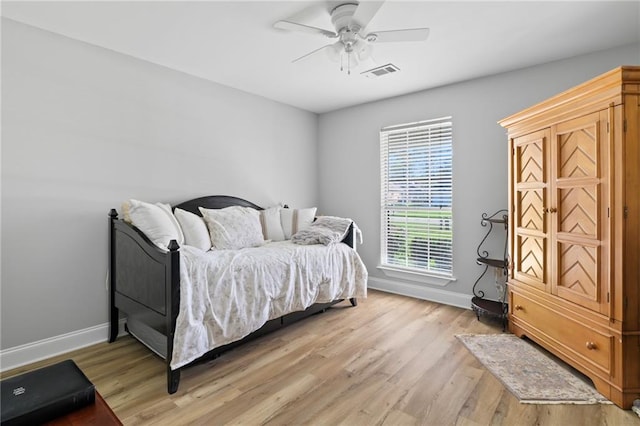 bedroom with light hardwood / wood-style flooring and ceiling fan