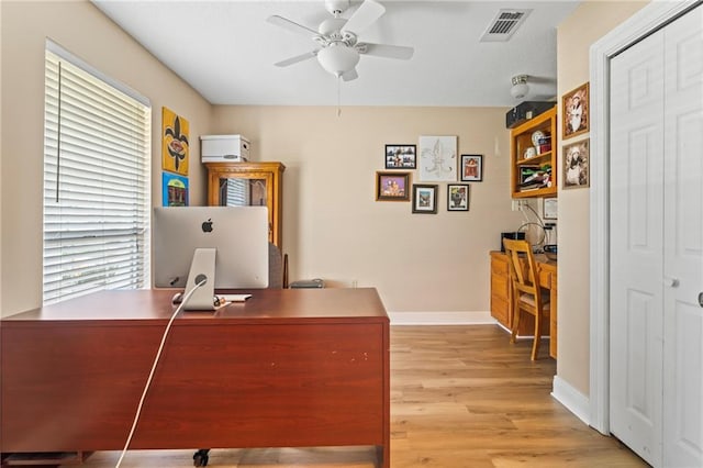 home office featuring light wood-type flooring and ceiling fan