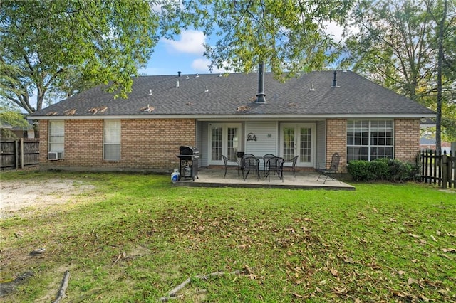 back of house with a yard, a patio area, and french doors