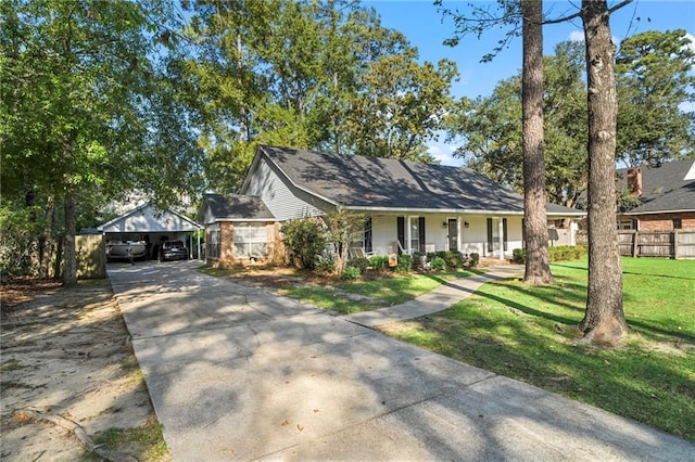 view of front of house with a porch, a garage, a front lawn, and an outdoor structure