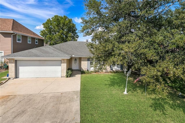 view of front of home with a garage and a front lawn