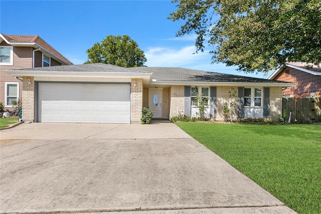 ranch-style home featuring a garage and a front lawn