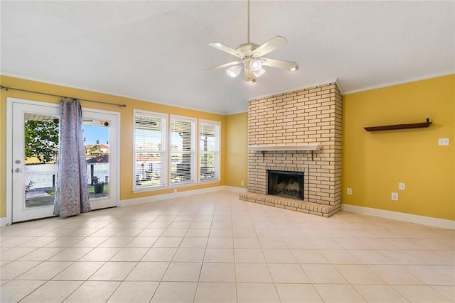 unfurnished living room with ceiling fan, light tile patterned flooring, ornamental molding, and a fireplace