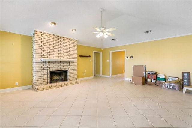 tiled living room with crown molding, ceiling fan, vaulted ceiling, and a brick fireplace