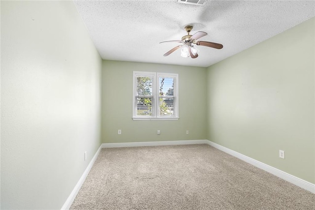 carpeted empty room featuring ceiling fan and a textured ceiling