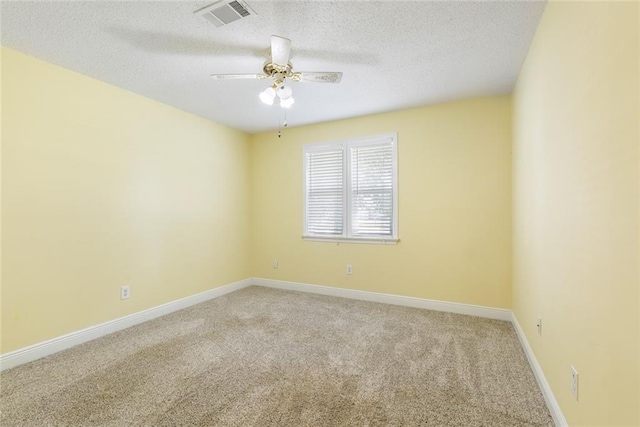 unfurnished room featuring a textured ceiling, carpet floors, and ceiling fan