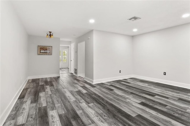 unfurnished room featuring dark wood-type flooring