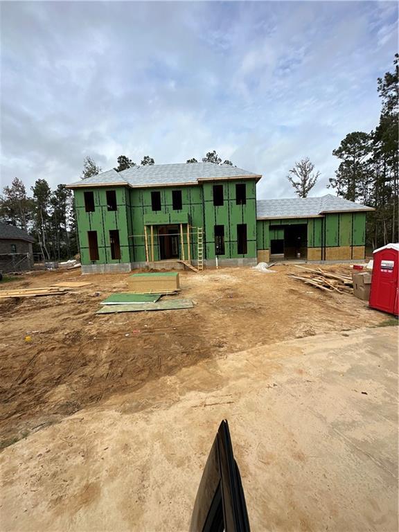 rear view of house featuring an outbuilding