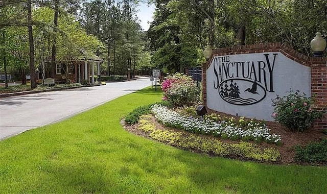 community / neighborhood sign with a lawn