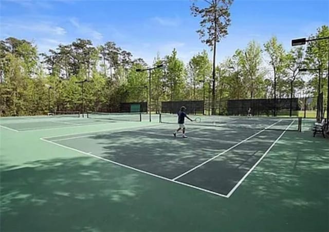view of sport court featuring fence