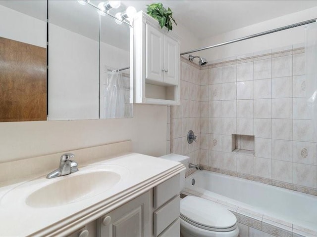 full bathroom with shower / tub combo with curtain, vanity, and toilet