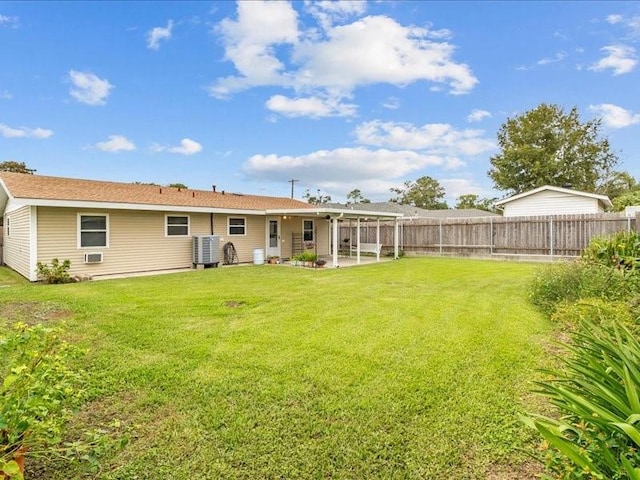 back of property featuring a lawn, a patio area, and cooling unit