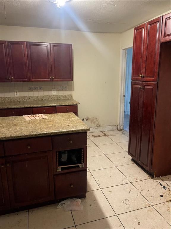 kitchen featuring decorative backsplash and light tile patterned flooring