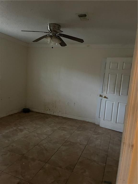 tiled spare room with ceiling fan and crown molding