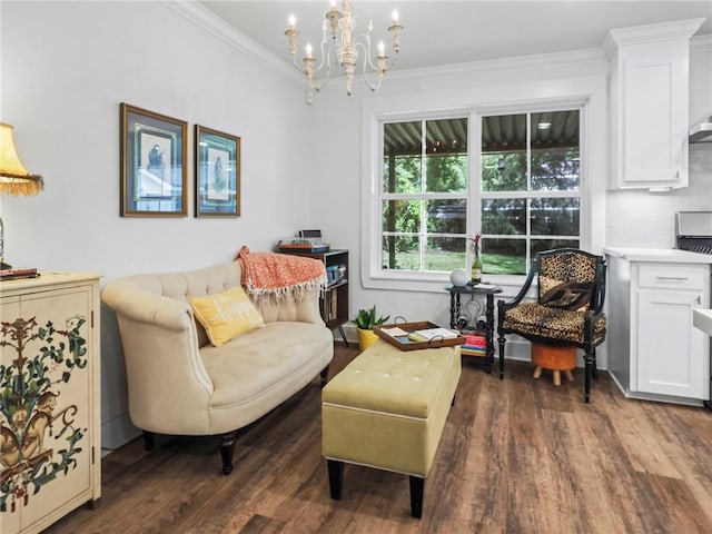 living area with dark hardwood / wood-style flooring, crown molding, and a notable chandelier