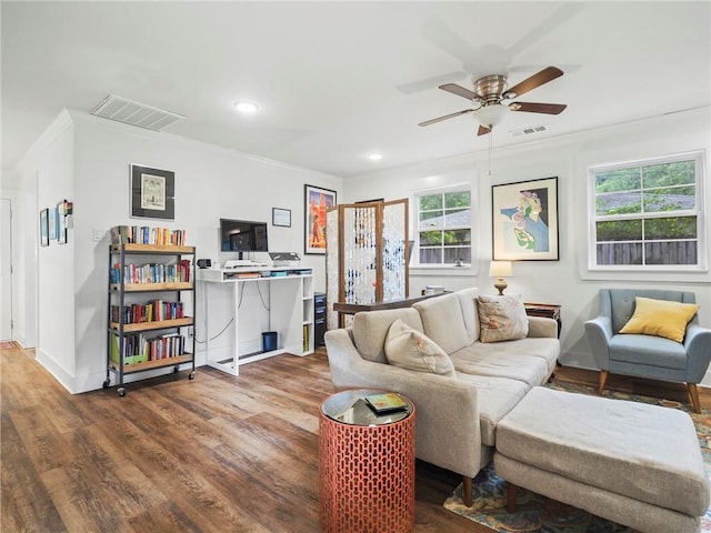 living room with ceiling fan, dark hardwood / wood-style flooring, and crown molding