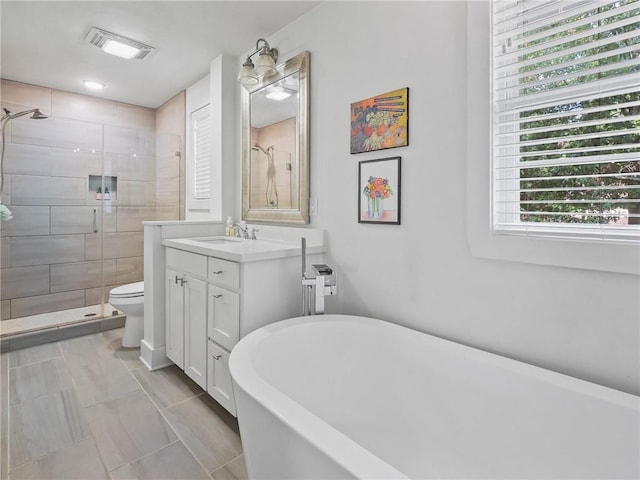 full bathroom featuring tile patterned floors, vanity, toilet, and independent shower and bath