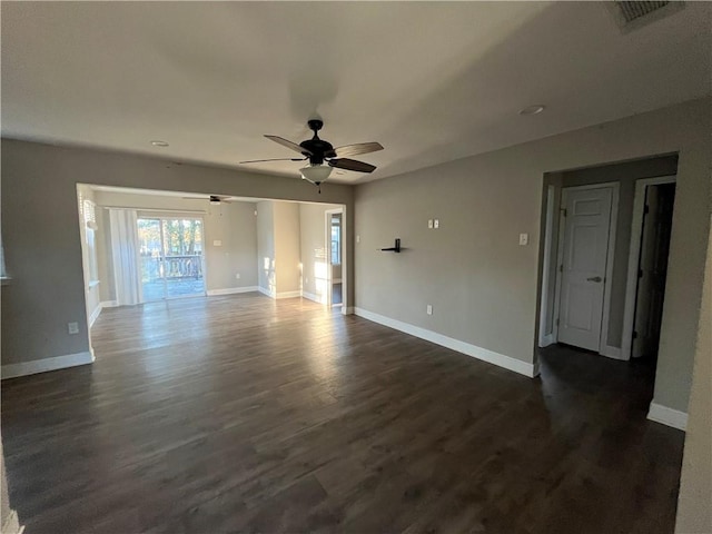 empty room with ceiling fan and dark wood-type flooring