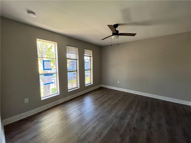 unfurnished room with ceiling fan and dark wood-type flooring