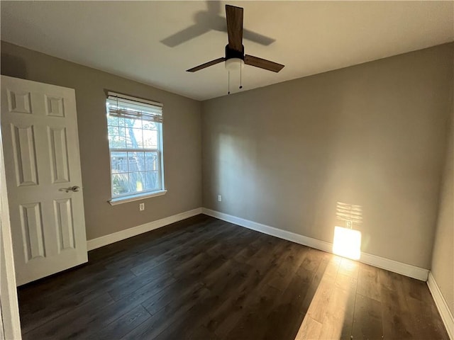 unfurnished room with dark hardwood / wood-style floors and ceiling fan