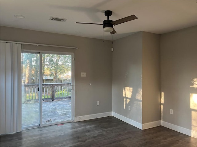 empty room featuring ceiling fan and dark wood-type flooring