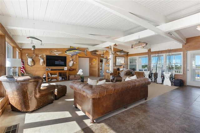 living room with wooden walls and lofted ceiling with beams