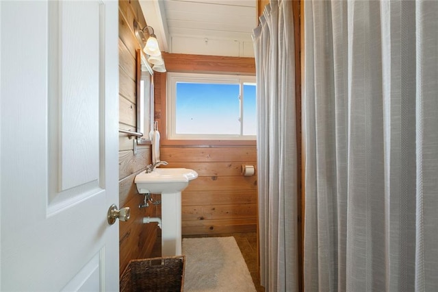 bathroom with wood walls