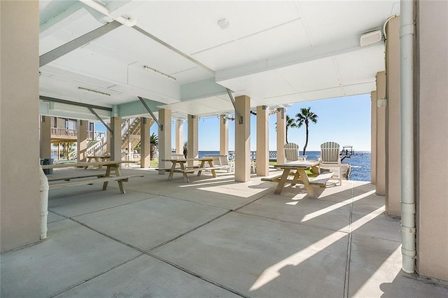 view of patio with a water view