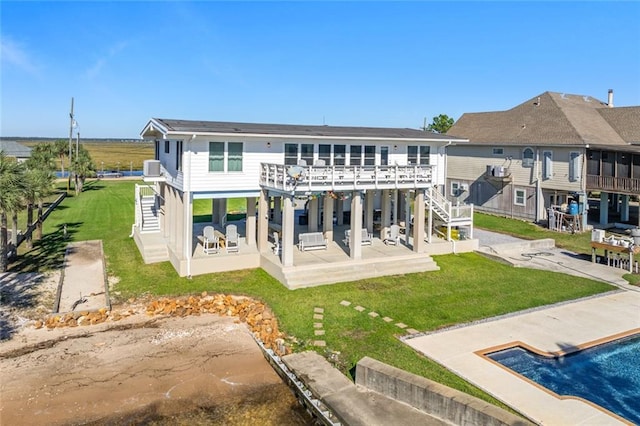 back of property with a lawn and a patio area