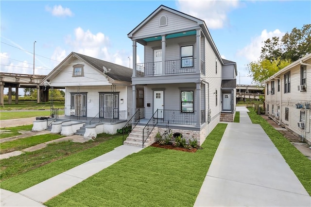 view of front of home featuring covered porch and a front yard