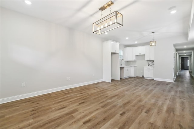 unfurnished living room featuring dark hardwood / wood-style flooring and sink