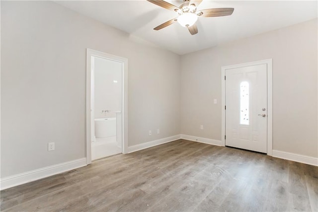 foyer entrance with ceiling fan and light hardwood / wood-style flooring