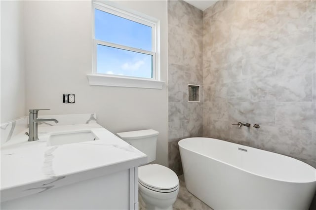 bathroom with a bath, vanity, toilet, and tile walls