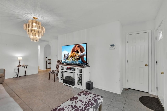 tiled living room featuring an inviting chandelier