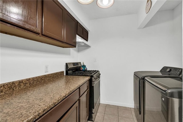 laundry area with light tile patterned flooring and washing machine and dryer