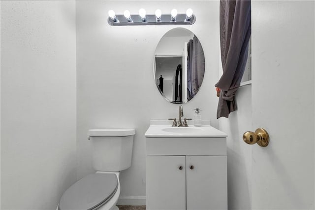 bathroom featuring vanity and toilet