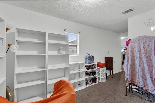 carpeted bedroom featuring a textured ceiling