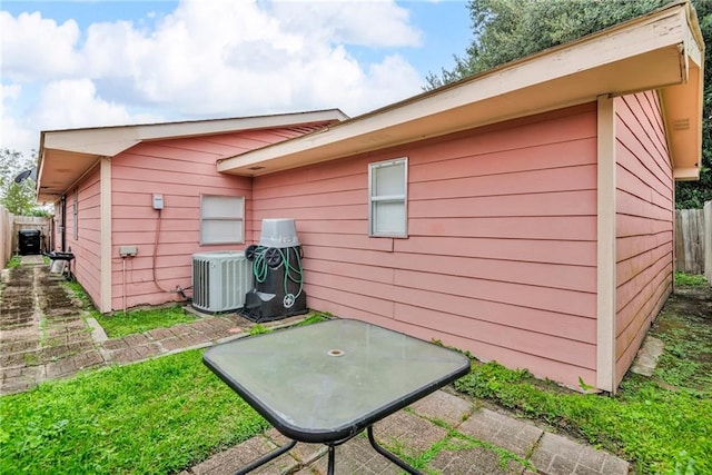 rear view of house with cooling unit and a patio