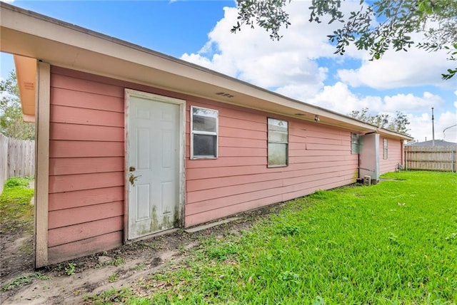 rear view of property with a yard