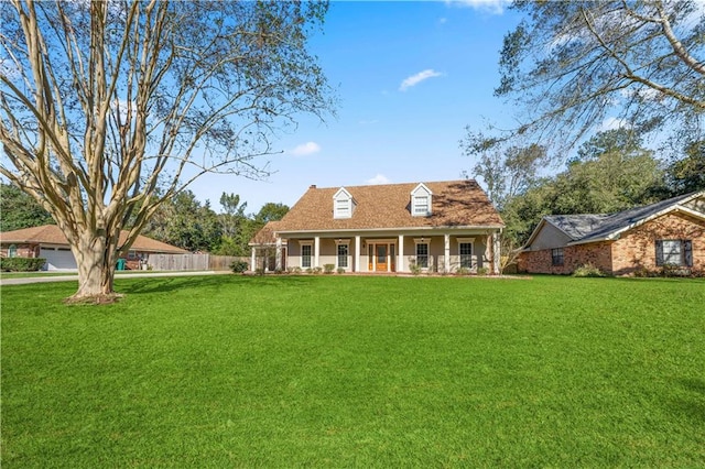 back of property with a lawn and a porch