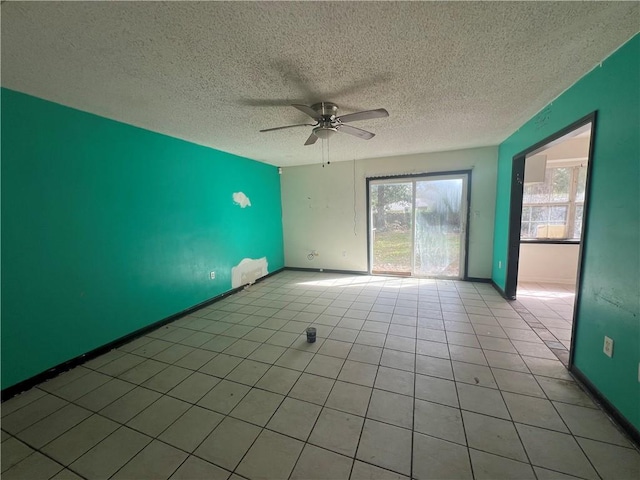 tiled spare room with ceiling fan and a textured ceiling