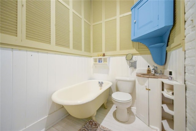 bathroom featuring vanity, toilet, and a tub