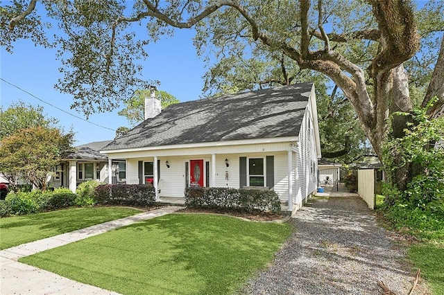 view of front of house with a front yard and covered porch