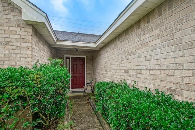 1210 Montgomery Blvd, Slidell, LA 70461 - view of exterior entry featuring a shingled roof and brick siding