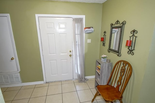 tiled foyer featuring a textured ceiling